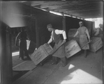 Loading Crates of Fatima and Piedmont Cigarettes by Cook Studio