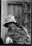 Boy Dressed in Tattered Clothing by Photographer unknown