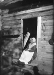 Woman Sitting in Cabin Doorway