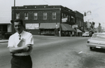 Man standing on Main Street and other men by Southside Sundry, Farmville, Va., August 1963