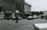 Police officer and pedestrians on Main Street, Farmville, Va., July 1963, #001
