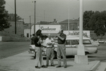 Man with camera and others in parking lot, Farmville, Va., August 1963, #003