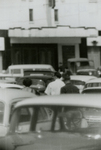 People walking through parking lot, Farmville, Va., August 1963